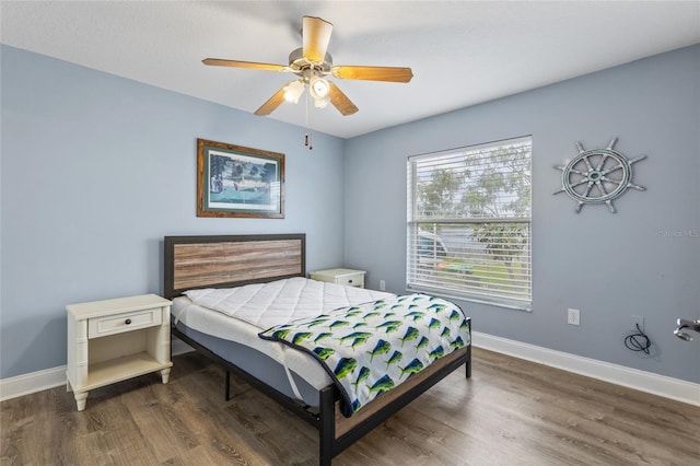 bedroom with dark hardwood / wood-style floors and ceiling fan