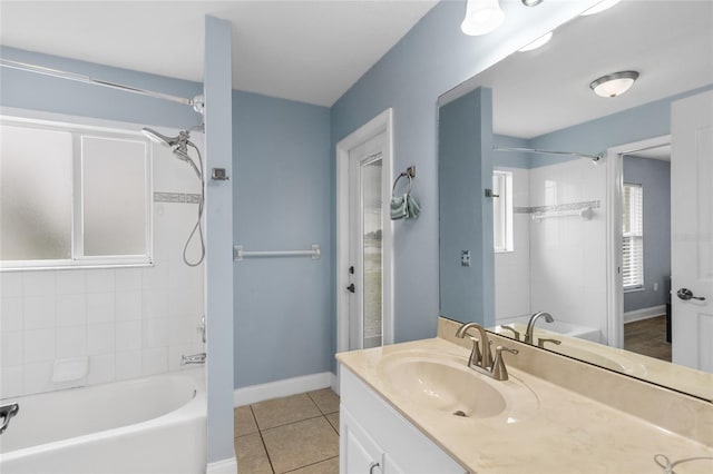 bathroom featuring tile patterned flooring, vanity, and tiled shower / bath