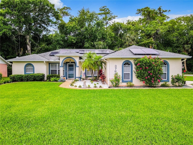 ranch-style home featuring solar panels, a porch, and a front lawn