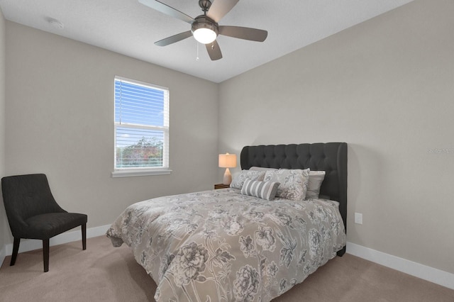 carpeted bedroom with a ceiling fan and baseboards