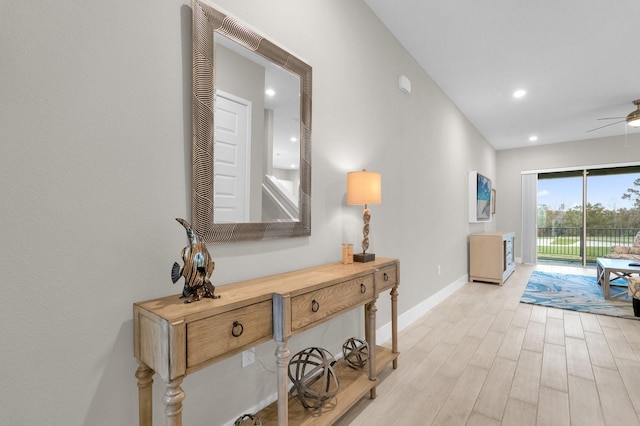 corridor with recessed lighting, light wood-style flooring, and baseboards