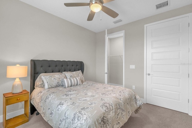 carpeted bedroom featuring a closet, visible vents, and a ceiling fan