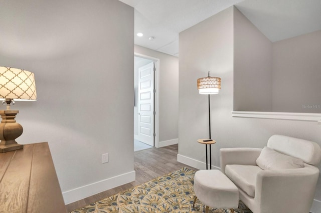 sitting room featuring baseboards and wood finished floors