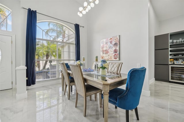 dining space with a wealth of natural light, wine cooler, and a towering ceiling