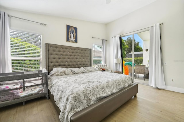 bedroom with light hardwood / wood-style floors, access to exterior, and ceiling fan