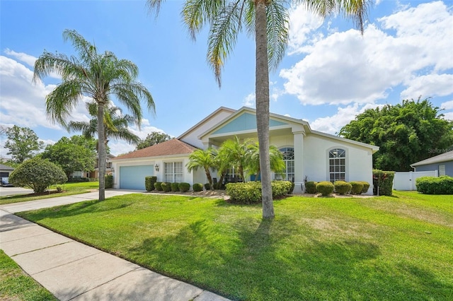 view of front of home featuring a garage and a front lawn