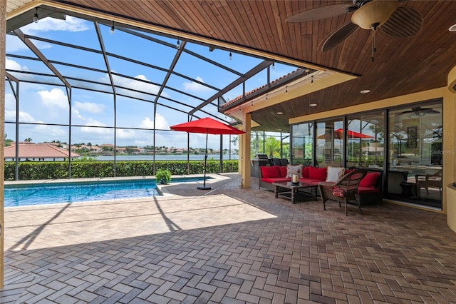 view of swimming pool featuring an outdoor living space, ceiling fan, a lanai, and a patio area