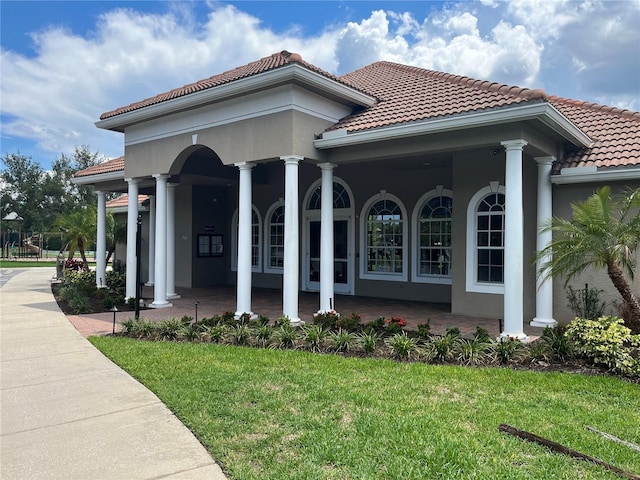 exterior space featuring a porch and a lawn