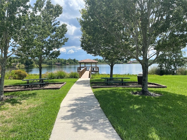 view of home's community featuring a gazebo, a water view, and a lawn