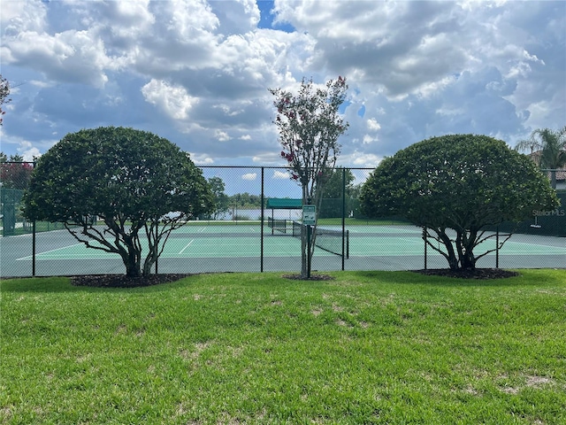 view of sport court featuring a lawn