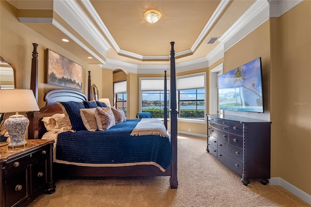 bedroom featuring a raised ceiling, light colored carpet, and ornamental molding