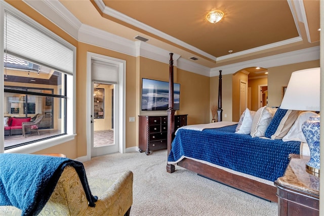 carpeted bedroom with a raised ceiling and ornamental molding