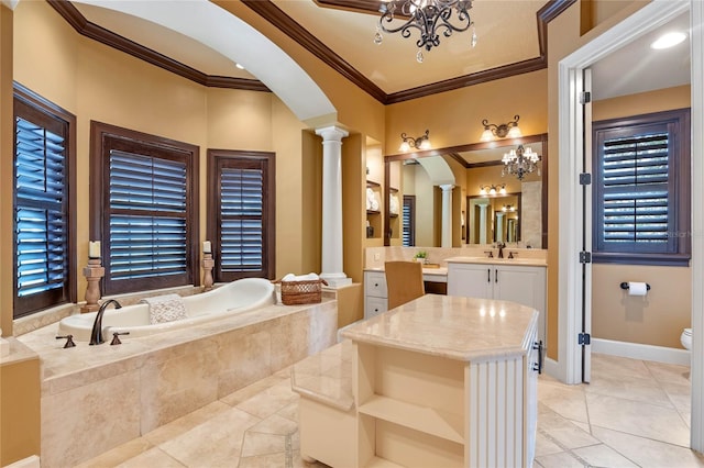 bathroom featuring vanity, an inviting chandelier, crown molding, ornate columns, and tiled bath