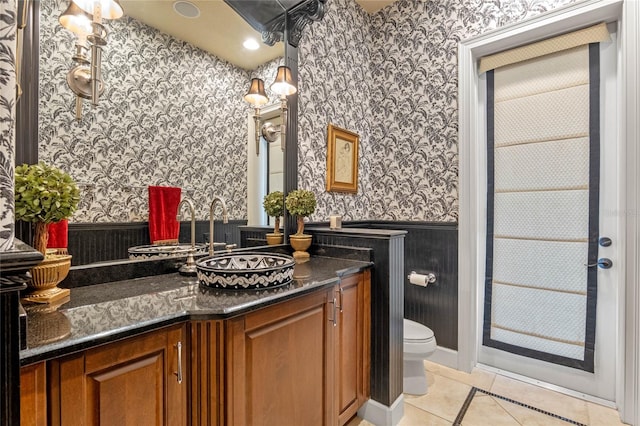 bathroom with tile patterned floors, vanity, and toilet