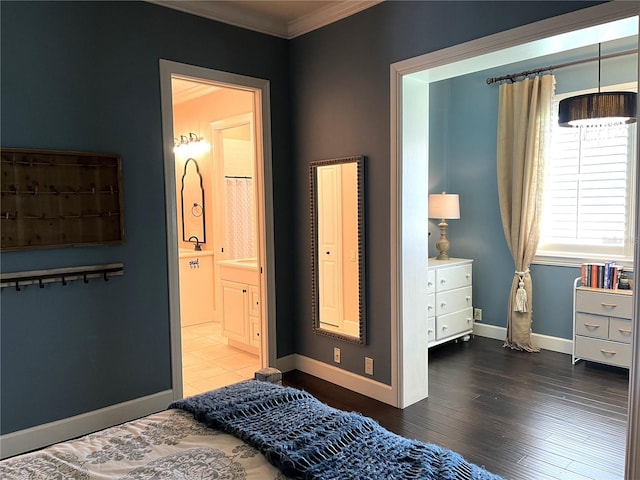 bedroom with hardwood / wood-style floors, ensuite bathroom, and ornamental molding