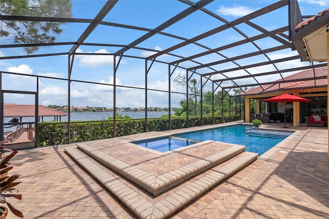 view of swimming pool with a lanai, a patio area, a water view, and an in ground hot tub