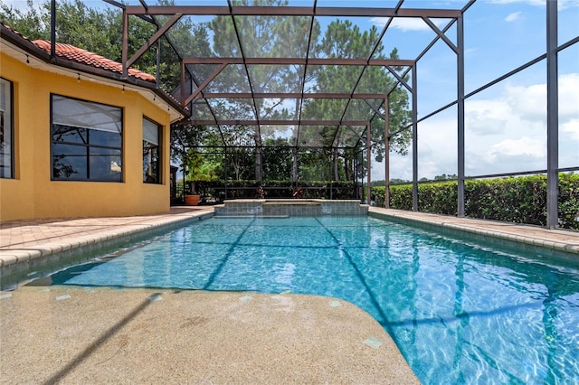 view of pool with glass enclosure