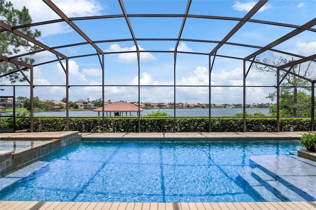 view of swimming pool with a lanai and a water view