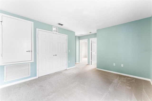 unfurnished bedroom featuring light carpet