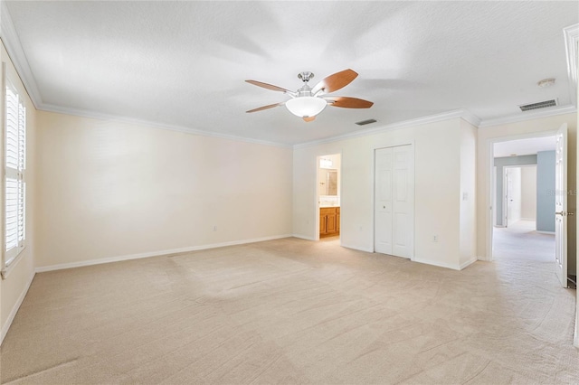 unfurnished bedroom featuring light colored carpet, ceiling fan, and ornamental molding