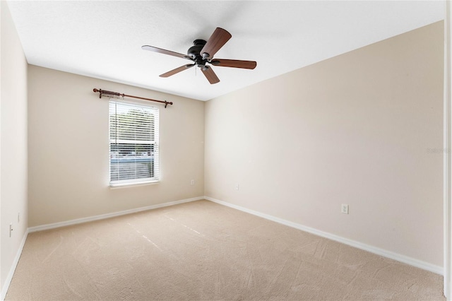 empty room with light colored carpet and ceiling fan