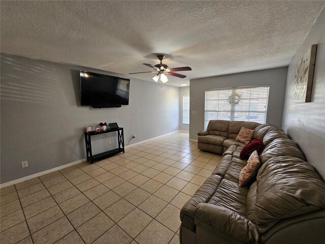 living room with a textured ceiling, ceiling fan, and light tile floors