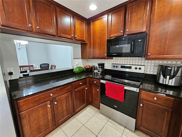 kitchen featuring backsplash, dark stone counters, stainless steel electric range oven, and light tile floors