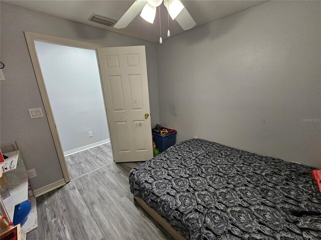 bedroom featuring ceiling fan and hardwood / wood-style floors