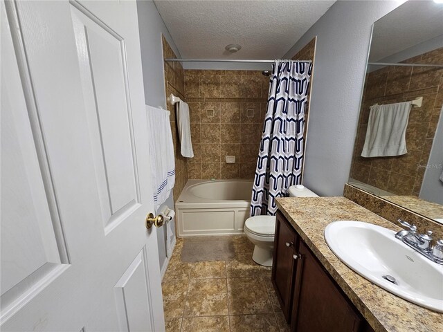 full bathroom with toilet, tile flooring, large vanity, shower / bath combo, and a textured ceiling