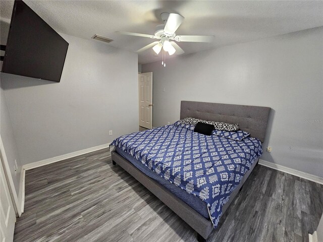 bedroom with ceiling fan and hardwood / wood-style flooring