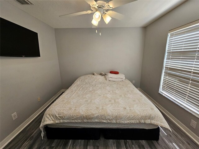 bedroom featuring ceiling fan and dark hardwood / wood-style flooring