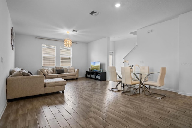 living room with hardwood / wood-style floors and a chandelier