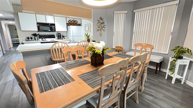 dining space with dark hardwood / wood-style flooring