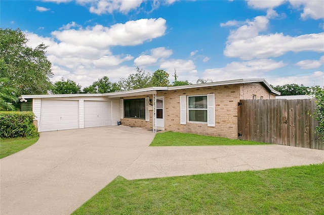 ranch-style house featuring a front yard and a garage