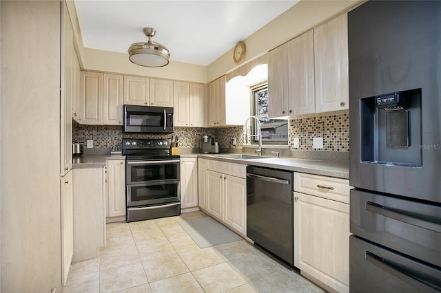 kitchen featuring backsplash, light tile patterned flooring, sink, and stainless steel appliances