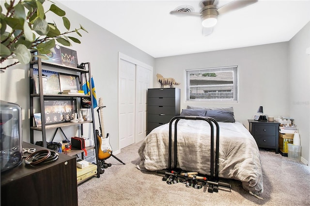 carpeted bedroom featuring ceiling fan and a closet