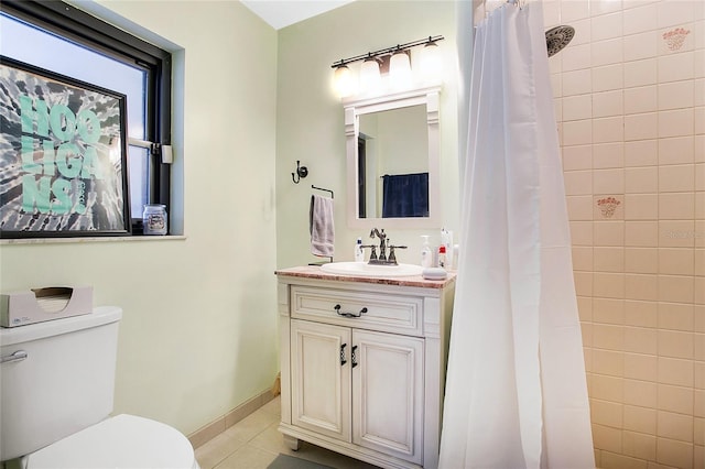 bathroom featuring toilet, tile patterned flooring, vanity, and walk in shower