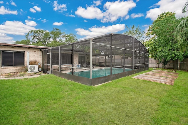 view of swimming pool with ac unit, a lanai, and a lawn