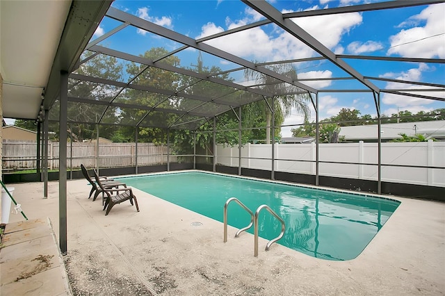 view of pool with a patio area and a lanai