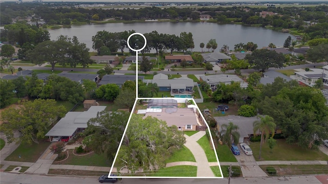 birds eye view of property with a water view