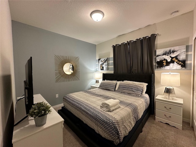 bedroom with carpet and a textured ceiling