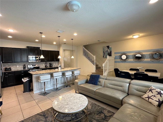 living room featuring light tile patterned floors and sink