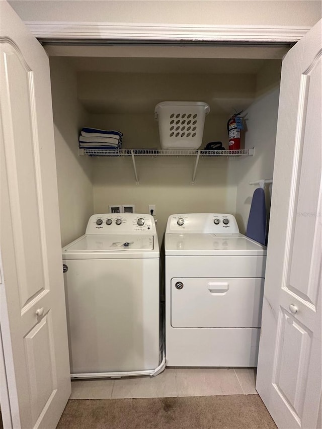 washroom featuring light tile patterned floors and washer and dryer