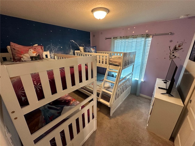 bedroom featuring carpet floors and a textured ceiling