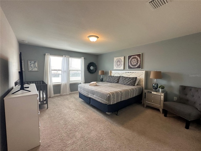 carpeted bedroom featuring a textured ceiling