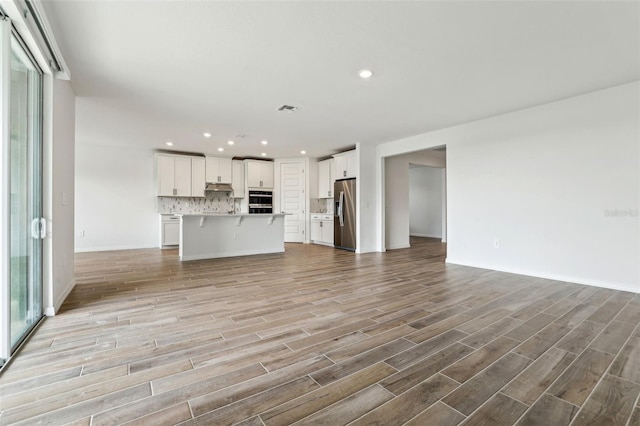 unfurnished living room featuring light hardwood / wood-style floors and a wealth of natural light