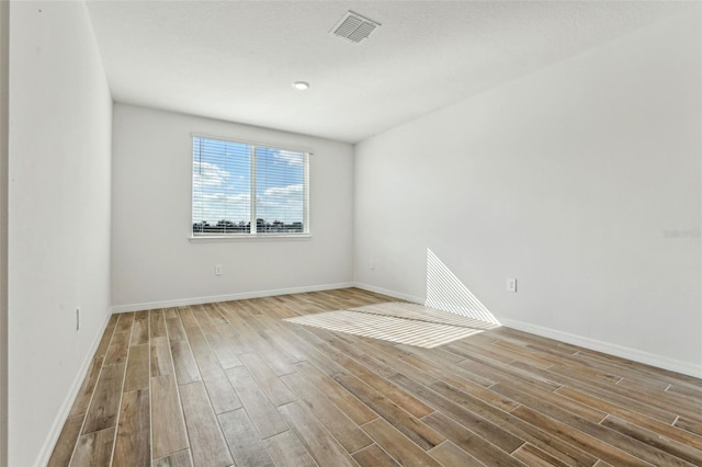 spare room featuring light hardwood / wood-style flooring