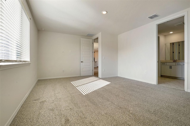 empty room featuring light carpet