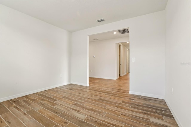 empty room with hardwood / wood-style flooring