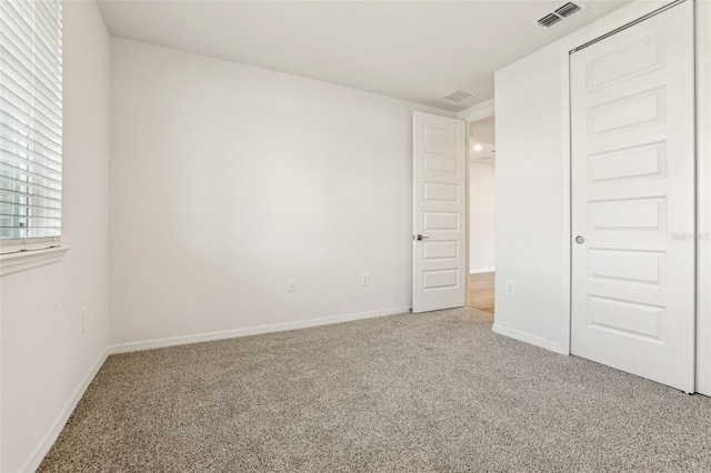 unfurnished bedroom featuring carpet and a closet